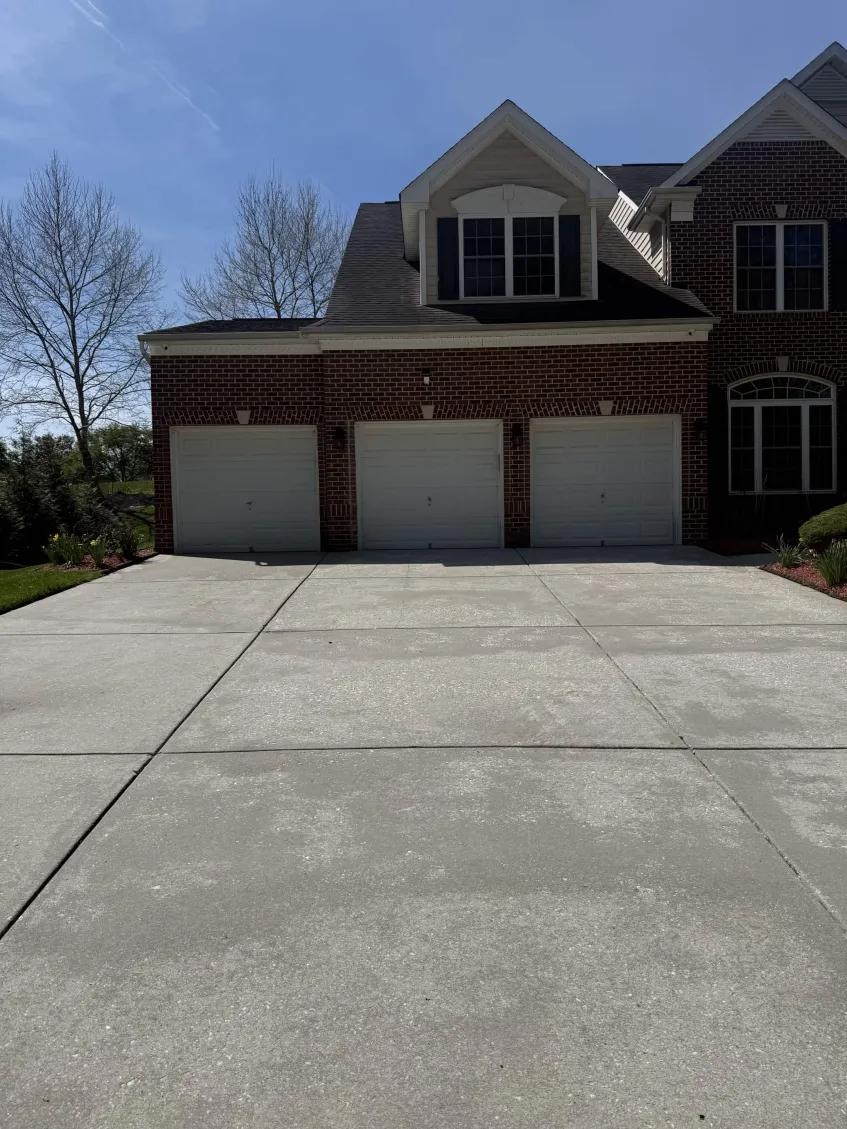 Concrete walkway being pressure washed