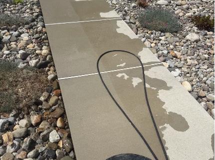 Concrete walkway being pressure washed